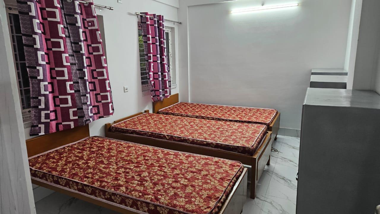 Triple sharing beds with patterned curtains